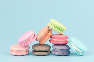 Sweet French macaroons cake (or macarons) with vintage pastel colored tone on pink background.