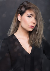 Portrait of beautiful model posing wearing black blouse.