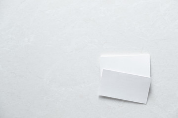 several clean white business cards with space for text on white surface