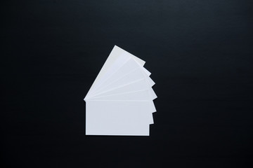  few clean white business cards with space for text on a black surface