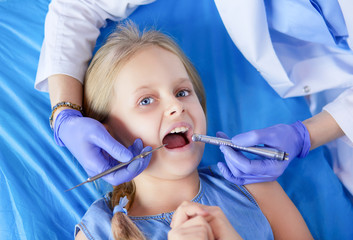 Little girl sitting in the dentists office