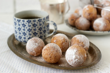 Vanilla krapfen doghnut with coffee. Rustic style.