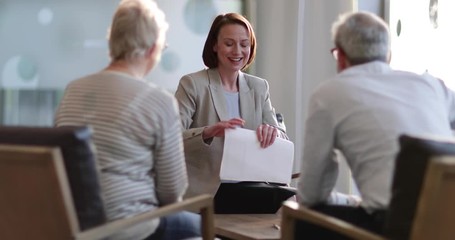 Senior couple shaking hands with financial advisor