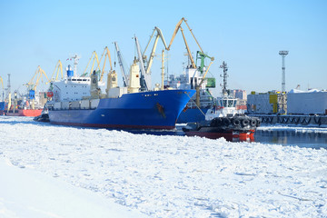 tugboat pulling a cargo ship in the Northern port