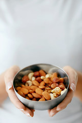 Healthy Food. Hands Holding Bowl With Nuts