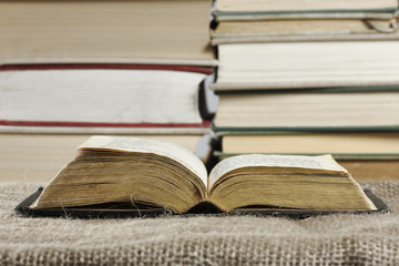 Open book in a hard cover on a table with a jute