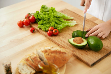 Nutrition And Diet. Close Up Of Woman Hands Cutting Products. 
