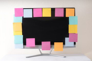 many colorful sticky notes on desk top computer monitor