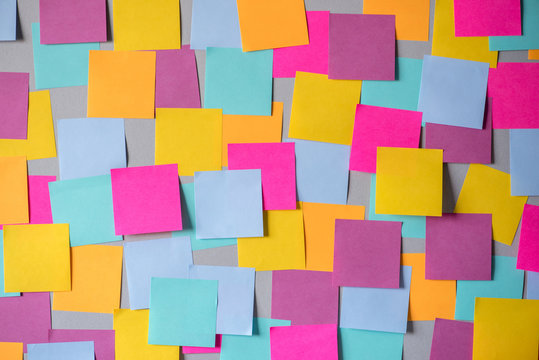 many colorful sticky notes on board background