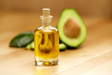 Food Ingredients. Avocado Oil In Bottle With Avocado On Table
