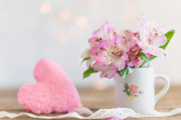 bouquet of flowers in a mug with a plush heart