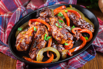 Chinese chicken wings with vegetables in sweet and sour sauce