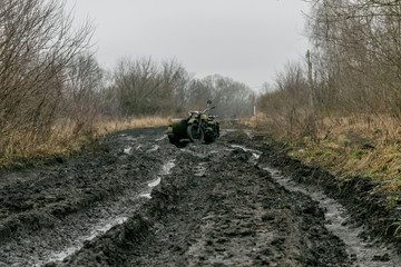 A motorbike in the ugly mudded road