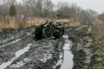 A motorbike in the ugly mudded road