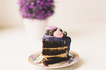 a piece of festive lilac cake with berries on a plate
