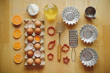 Ingredients for baking - flour, wooden spoon, rolling pin, eggs. Homemade tart pie preparation, dough with yeast and rolling pin on  rustic kitchen table