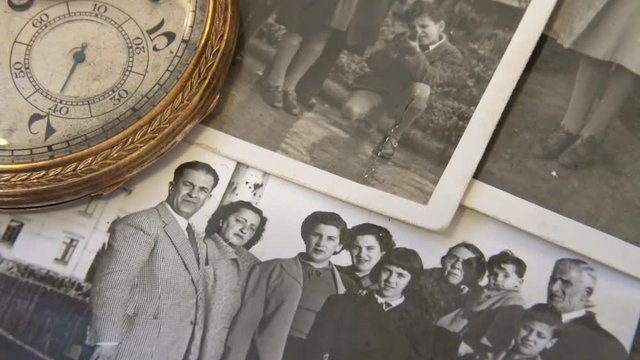 Old 1950's family photo with clock that marks the very fast time.