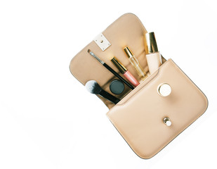 Flat lay of woman handbag accessories and cosmetics on  white background.