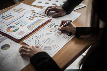 Startup business people group meeting. People group sitting on conference together and making notes. hands pointing at business document during discussion at meeting.
