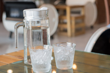two glasses of ice on table.