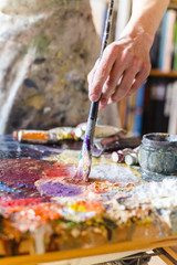 Close up of woman artist painting oils in his studio, Watercolor palette