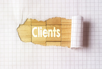 Paper tear on cube wood background with client text
