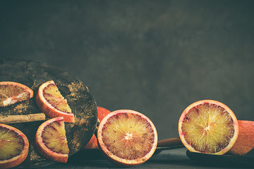 Blood oranges, on dark and rustic background