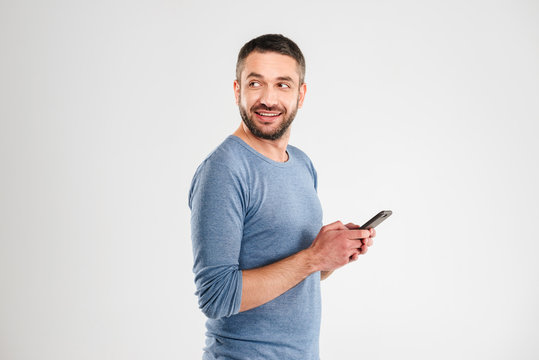 Cheerful man chatting by mobile phone.