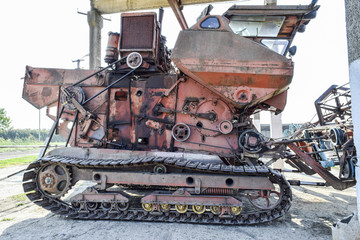 Old rusty disassembled combine harvester.