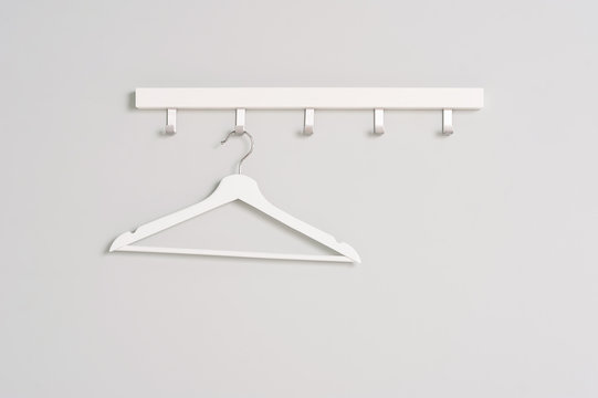 White Clothes hanger on a gray wall background