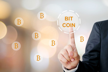 Cryptocurrency and Bitcoin concept, Businessman hand touch bitcoin icon over blur background, banner