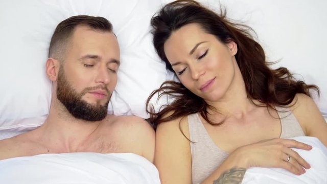 Beautiful couple lying in a bed.