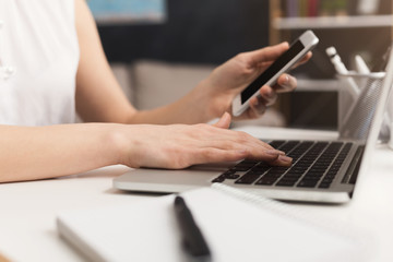 Unrecognizable girl typing on laptop