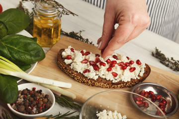 Woman making tasty bruschettas for healthy snack, closeup