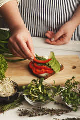 Woman making tasty bruschettas for healthy snack, closeup