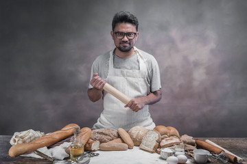 Man preparing buns at table in bakery