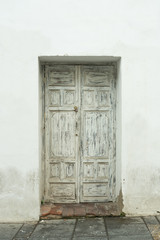 Ancient white wooden entrance door