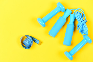 Weight loss and sports concept. Centimeter near sport equipment