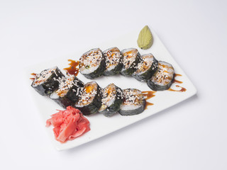 Salmon and caviar rolls on white background, close-up