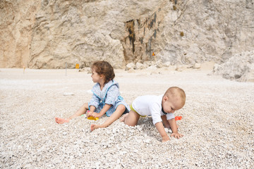 Sister and Brother Playing with Stones