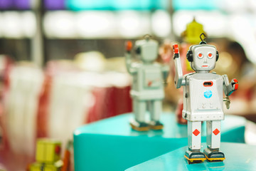 Old vintage gray robot toy on a pedestal. Robotics and design of the past. Conceptual background of Technology.