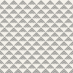 Regularly repeating geometric tiles of striped triangles.