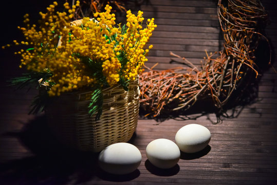 Basket of mimosa with Easter eggs