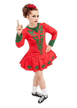 Beautiful woman in dress for Irish dance showing up by finger isolated