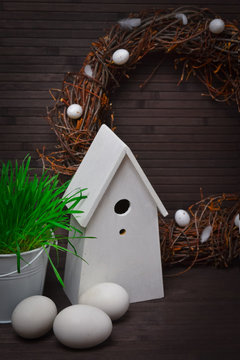 Easter wreath with a birdhouse and eggs