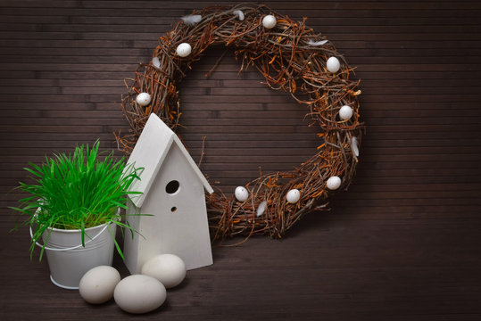 Easter wreath with a birdhouse and eggs