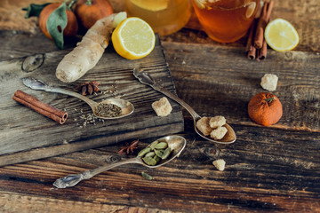 Vitamin tea with lemon and honey, ginger and spices. The concept of spring beriberi and colds. on a wooden table