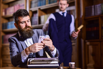 Men in suits with busy faces. Writer counts honorarium