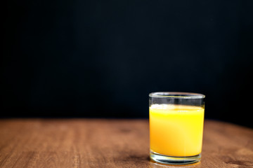 orange juice on a wooden background
