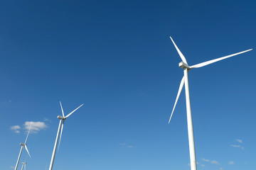 Wind turbine farm in the field - a renewable energy source